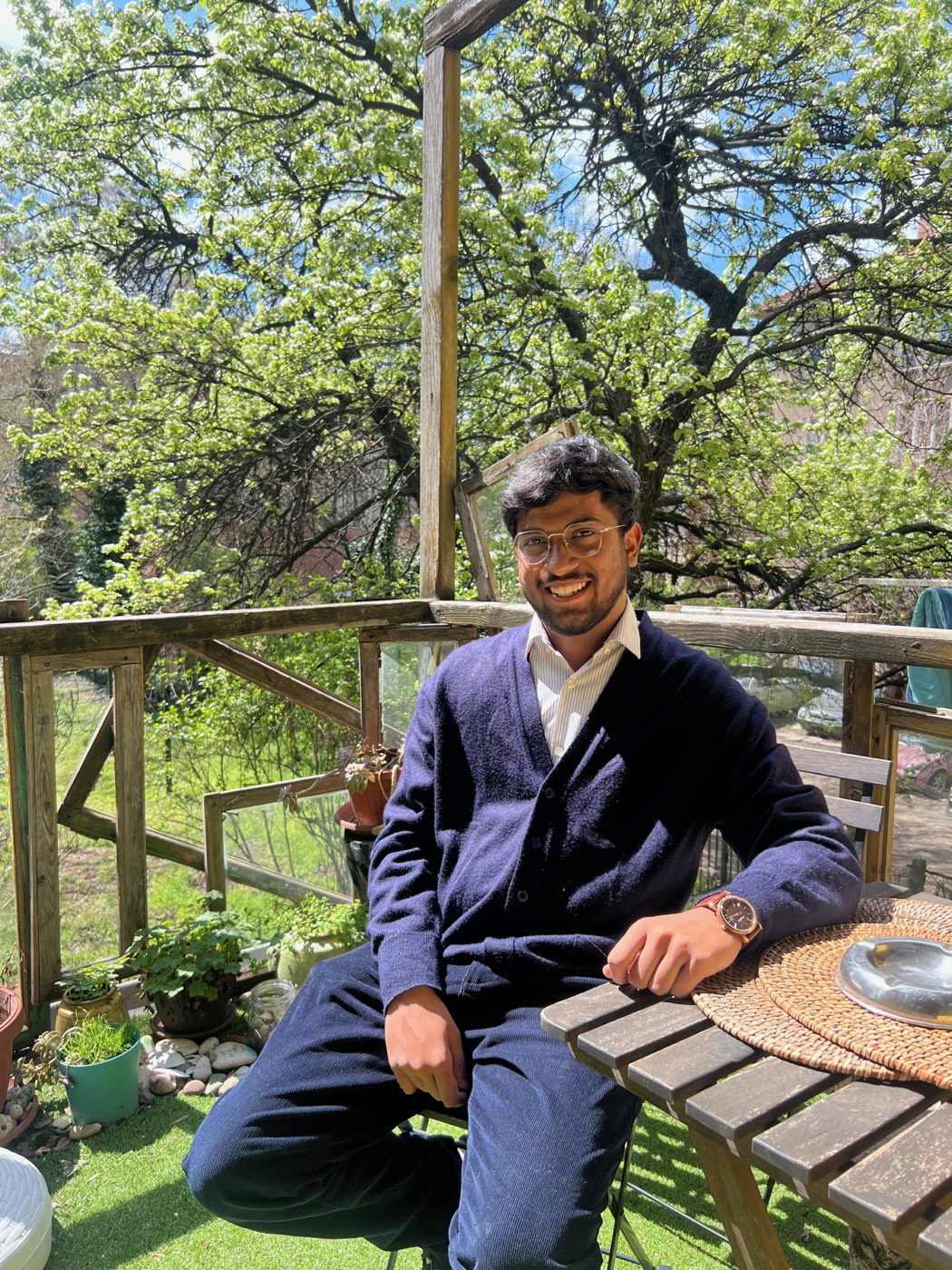 BhoumiK at a garden table under trees on the final day in Sofia
