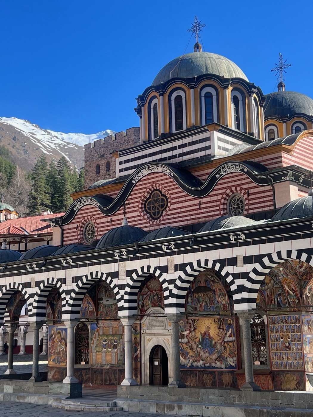 The painted church and striped facade at Rila Monastery