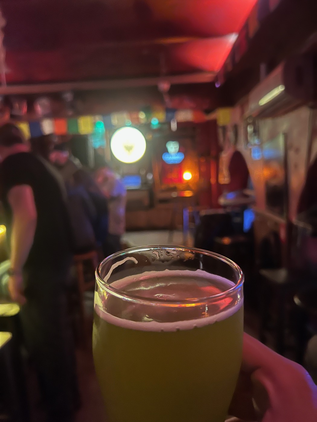 A beer under red and green bar lights near Vitosha Boulevard
