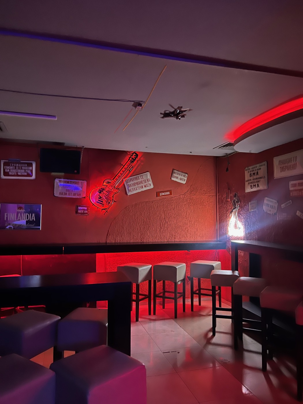 Red interior and neon guitar inside Sound Wave in Sofia